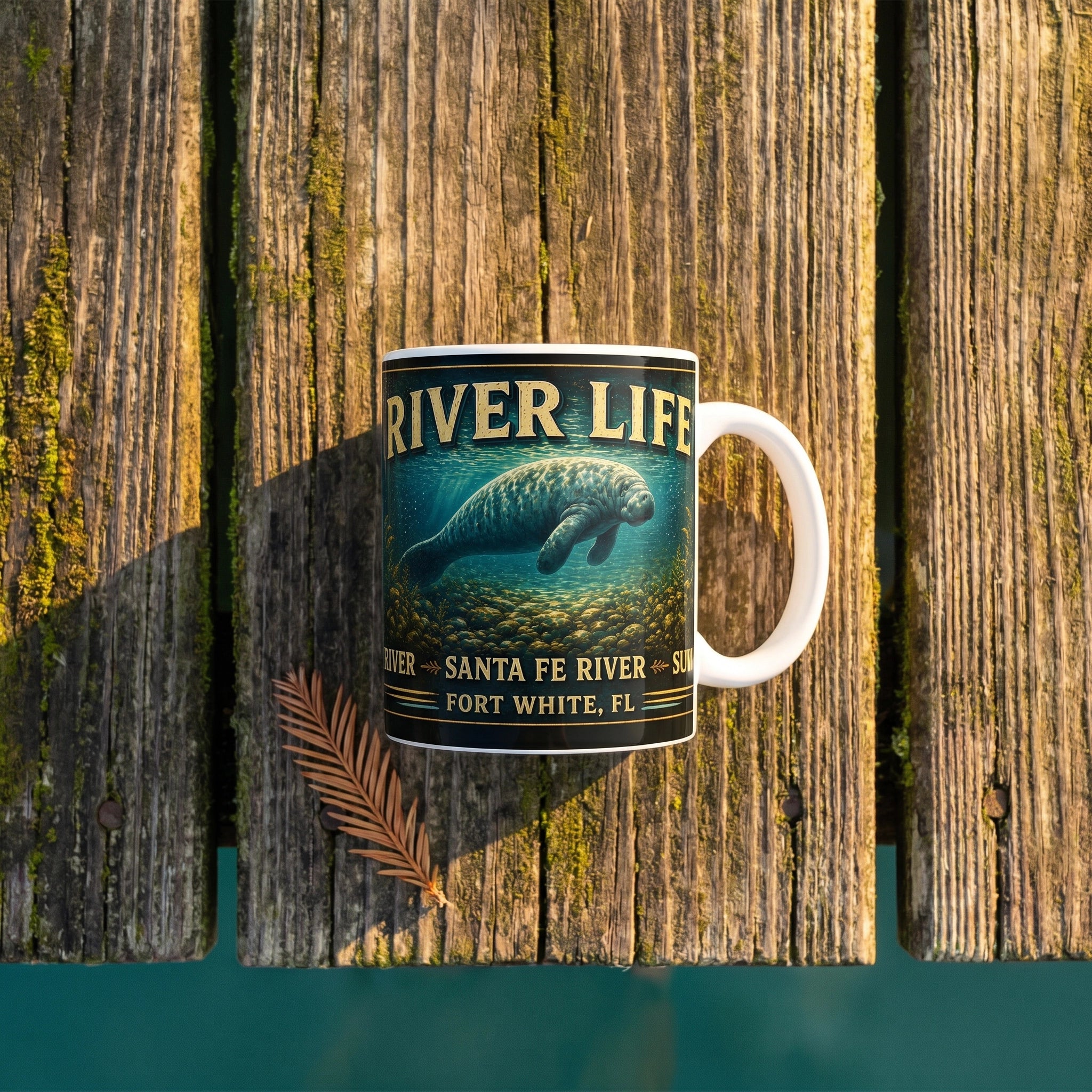 River Life Ceramic Mug Manatee Golden Springs flat-lay on moss-covered dock