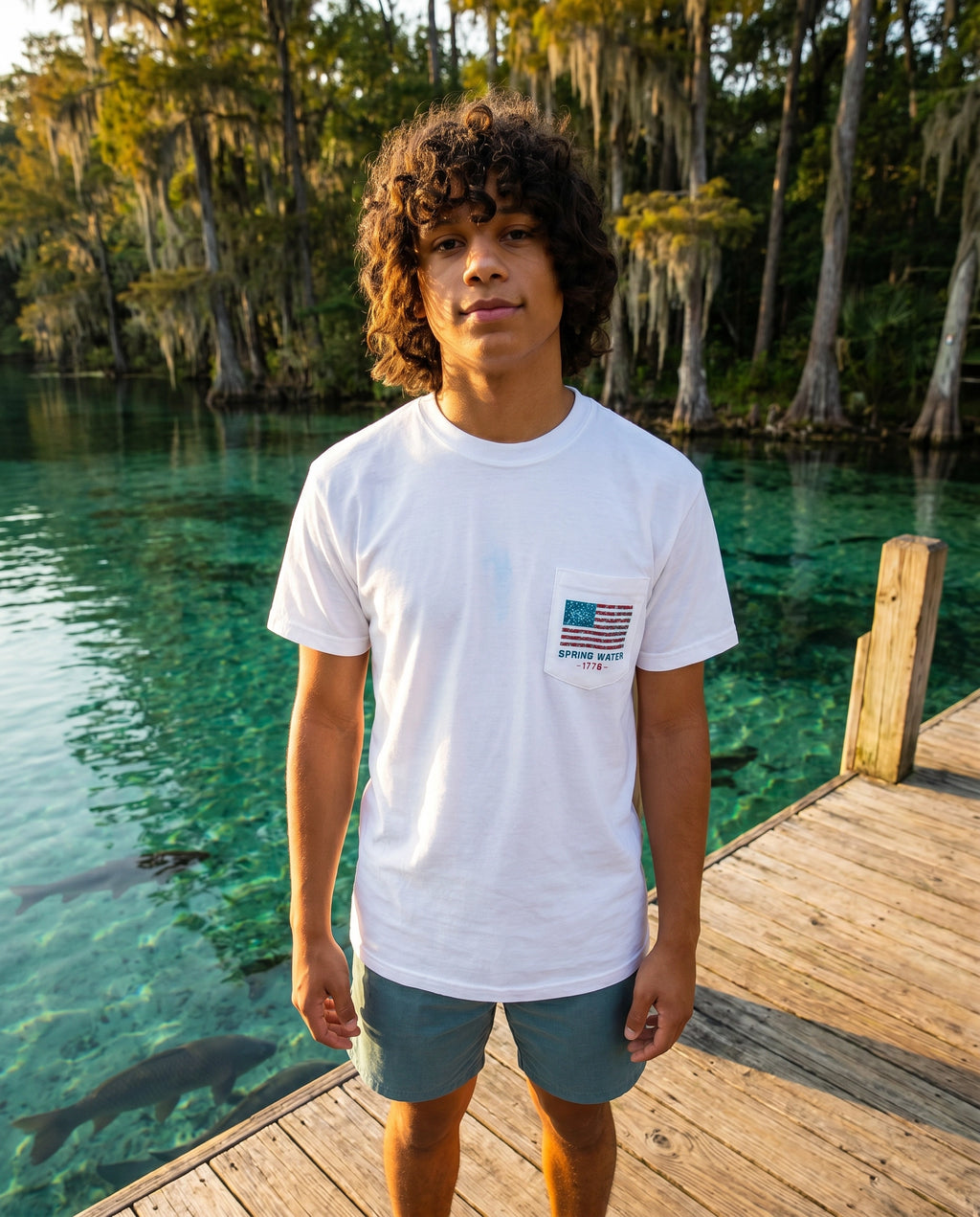America 250th Anniversary Tee lifestyle on dock over teal spring water