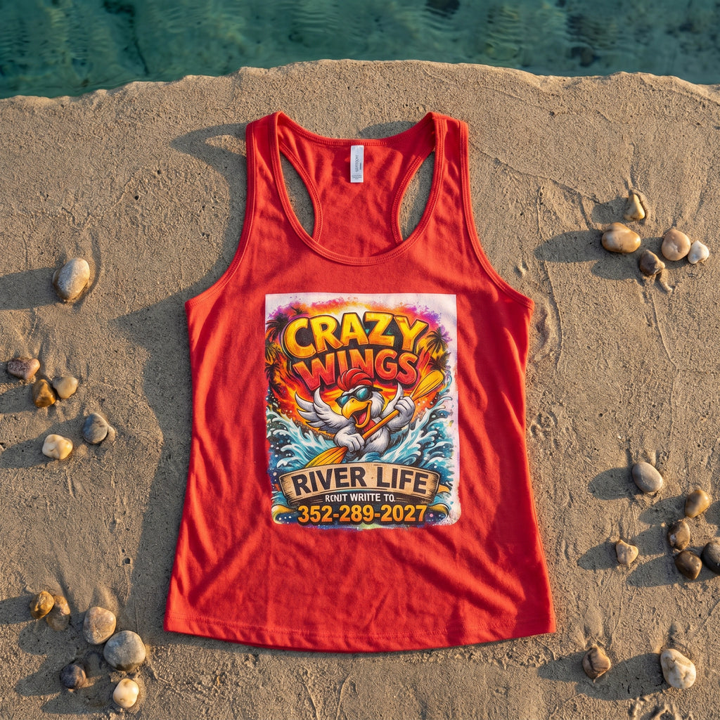 The Cheri Tank Crazy Wings flat-lay on sandy riverbank