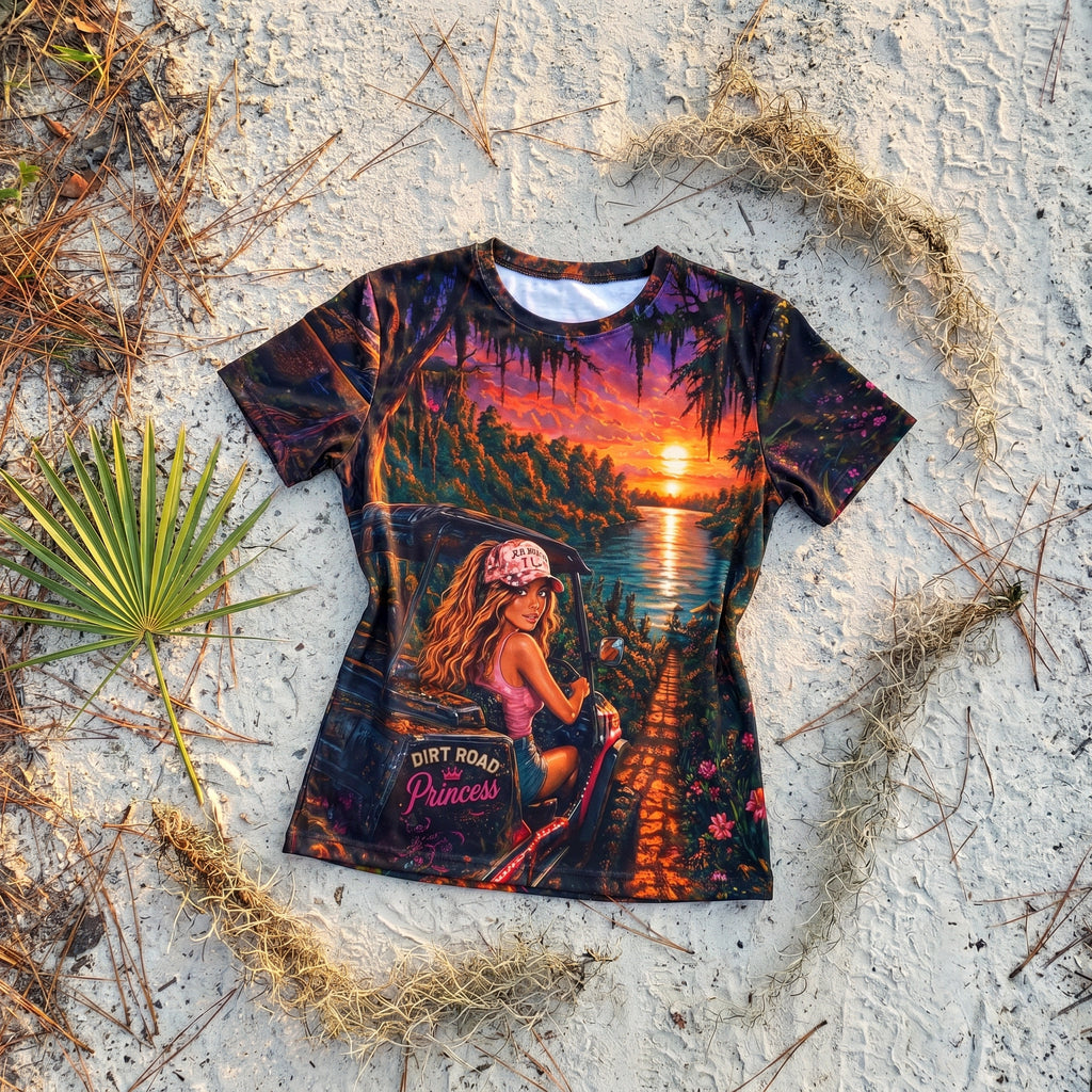 Dirt Road Princess AOP tee flat-lay on sandy dirt road
